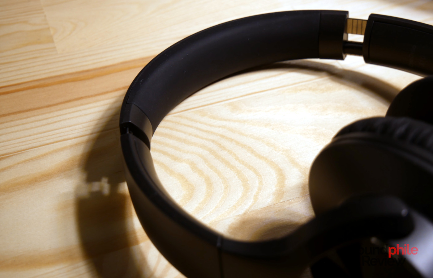 Close-up of OneOdio A10 ear cup highlighting ANC microphone and cushion
